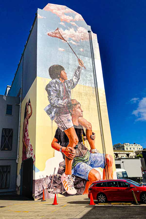3-storey high mural of three children catching clouds in a net