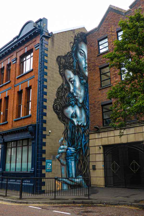 street art in Belfast by Starfighter three portraits of a woman