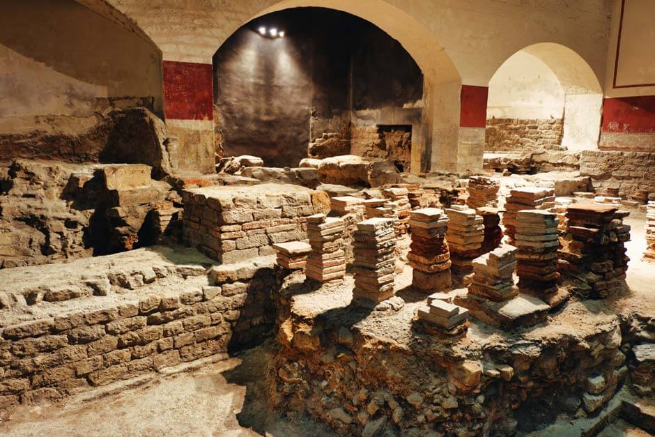 remnants of the ancient sauna in the Roman Baths in Bath with stacks of stone slates used for the distribution of the warm air